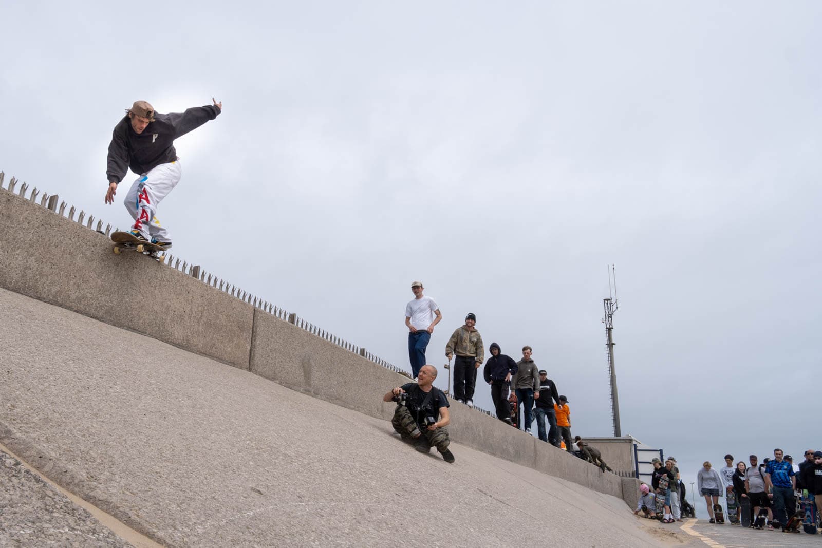 Skater stalls his trick atop concrete sea defences