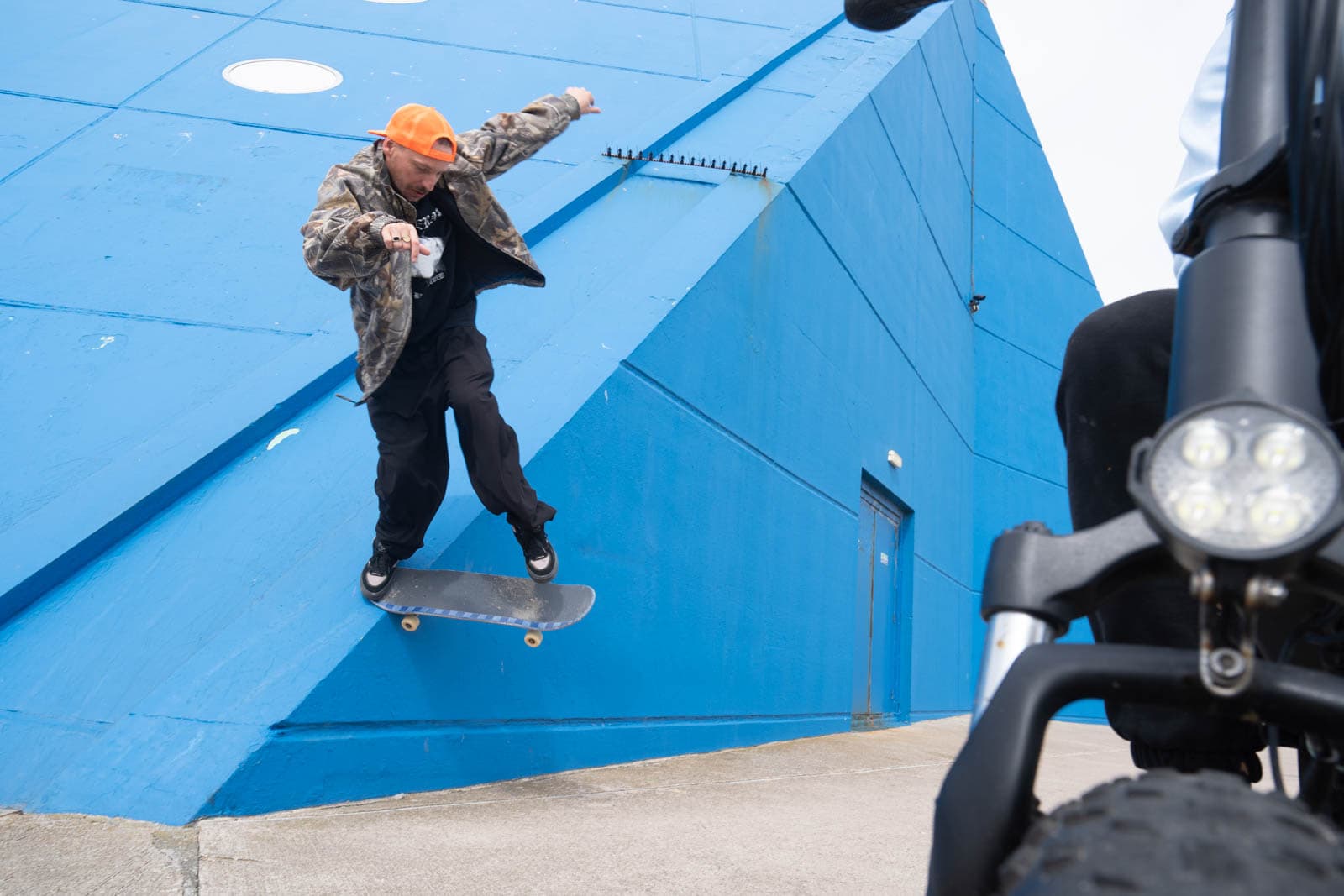 A skater slides his board on seaside architecture