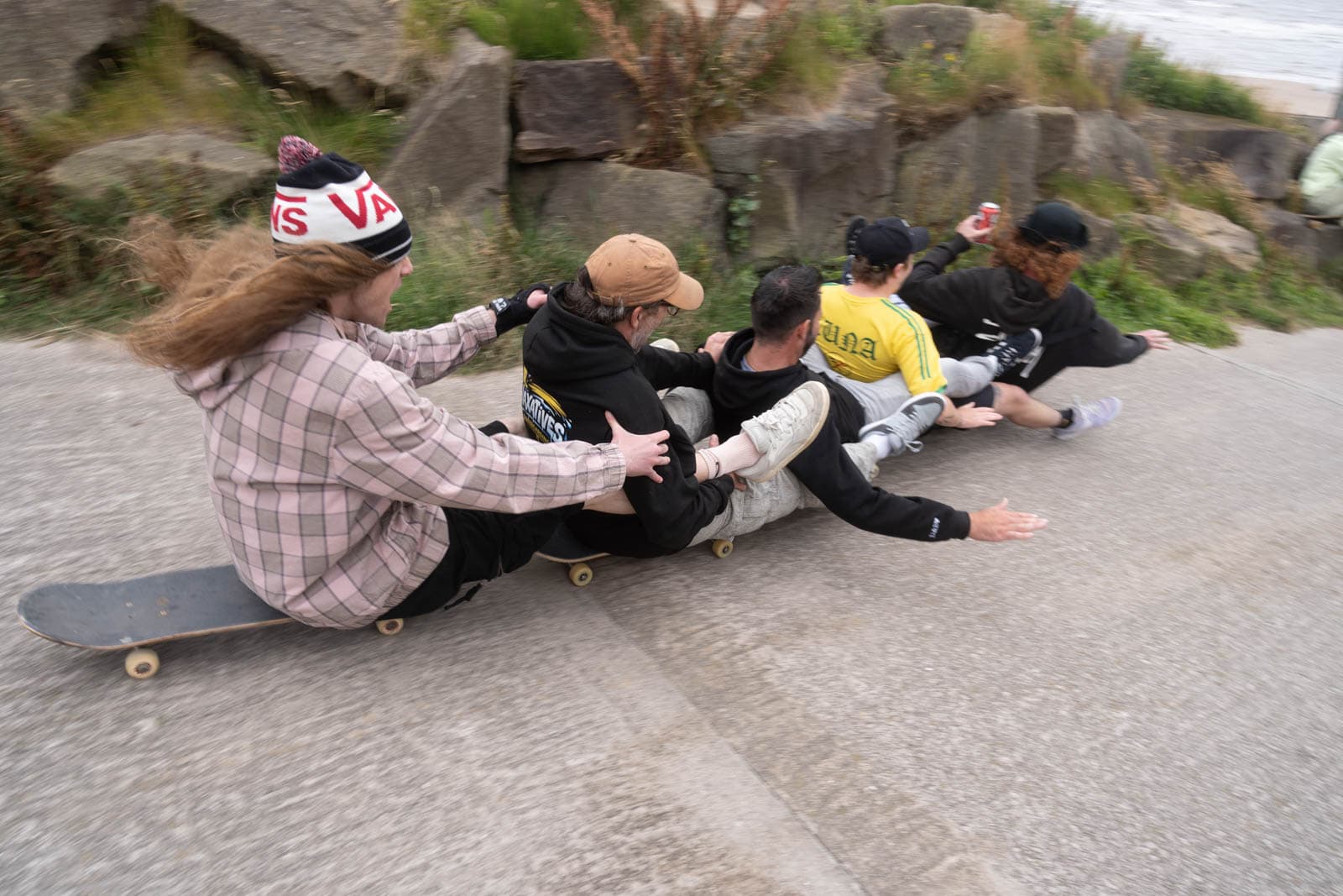 Skaters form a train riding downhill