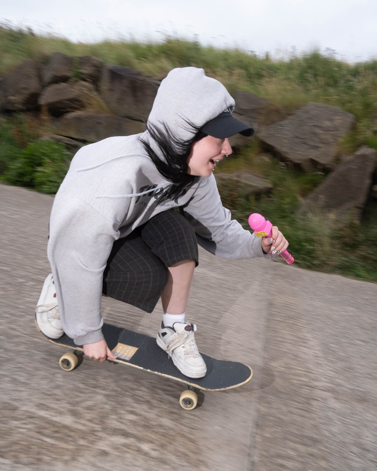 Skater brandishes her pink microphone in style